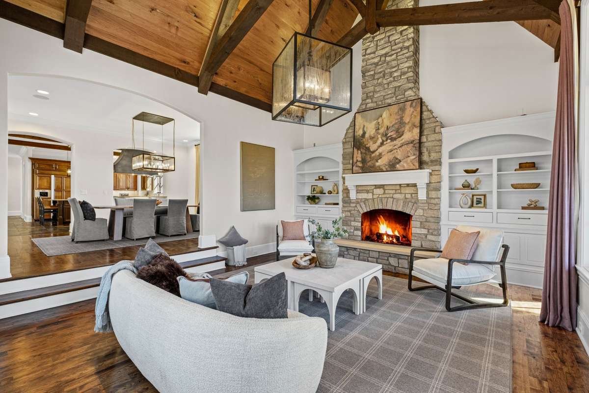 A warm and inviting retreat with another fireplace, fresh flooring, and a cozy atmosphere- perfect for relaxing or gathering with friends.