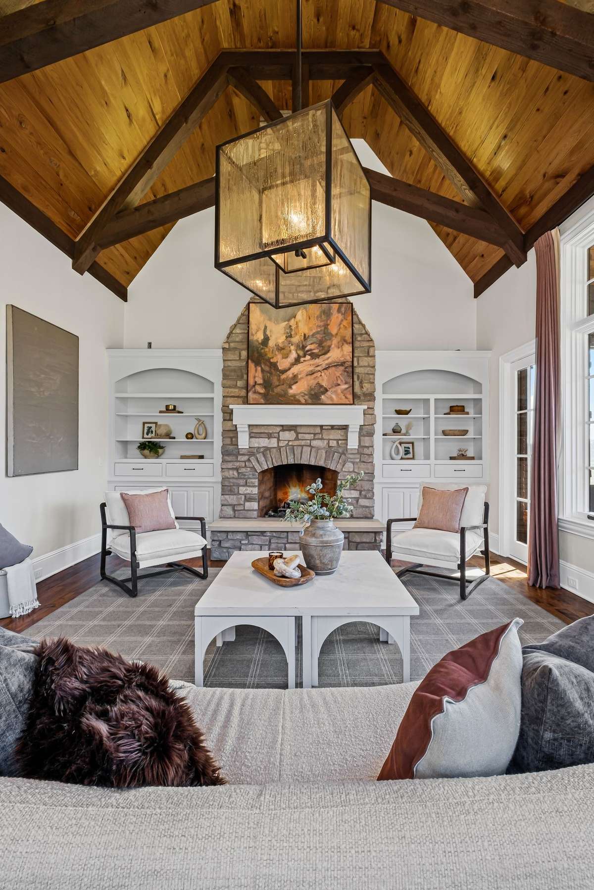 A warm and inviting retreat with another fireplace, fresh flooring, and a cozy atmosphere- perfect for relaxing or gathering with friends.