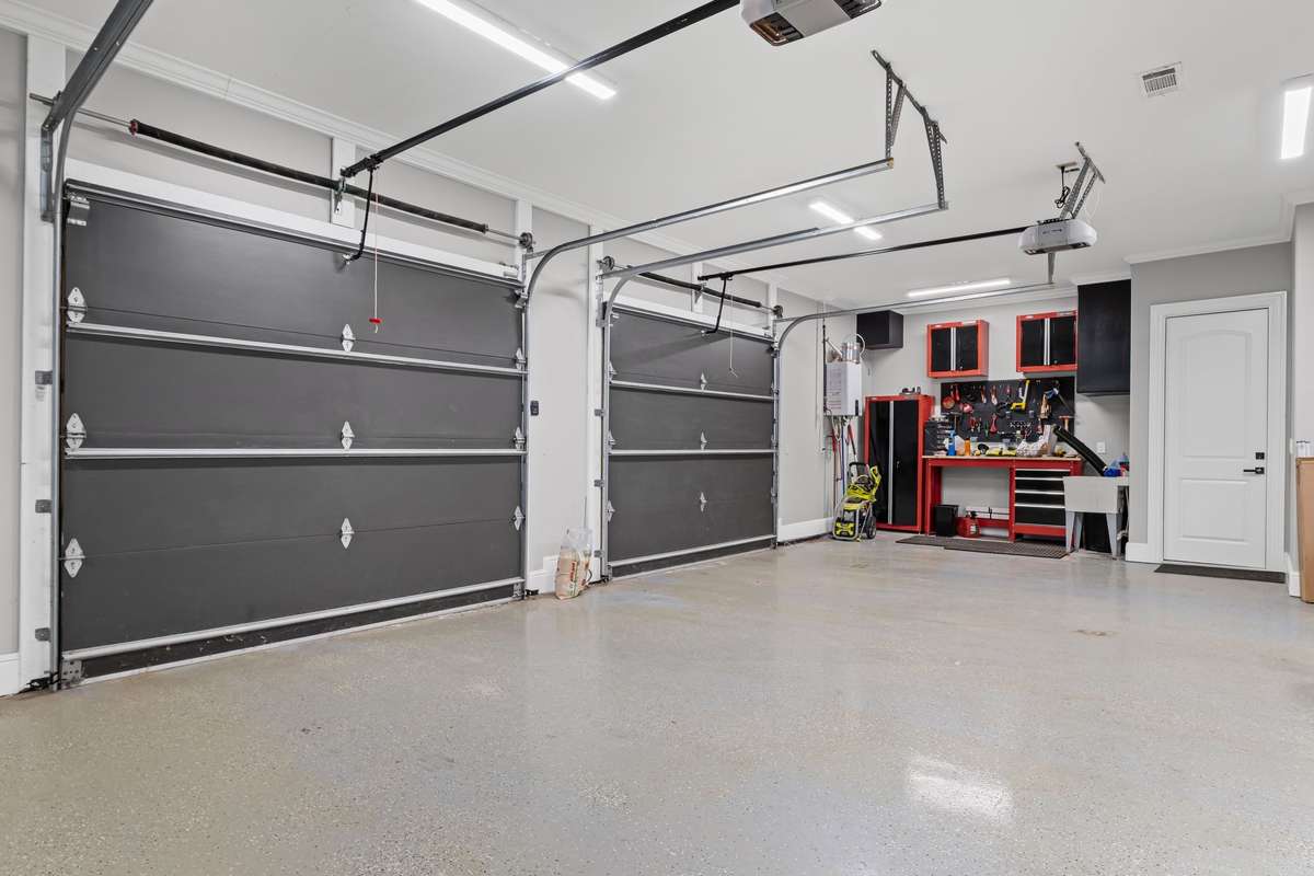 Three car garage offer ample space for parking, storage, and utility.
