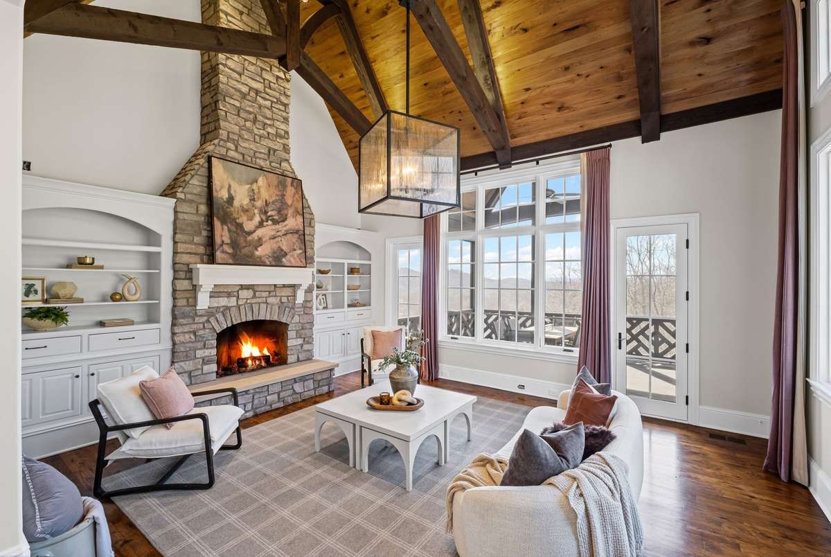 A warm and inviting retreat with another fireplace, fresh flooring, and a cozy atmosphere- perfect for relaxing or gathering with friends.