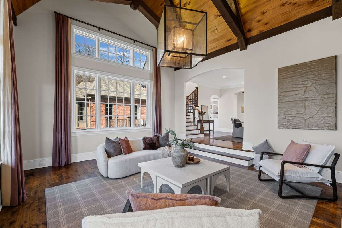 A warm and inviting retreat with another fireplace, fresh flooring, and a cozy atmosphere- perfect for relaxing or gathering with friends.