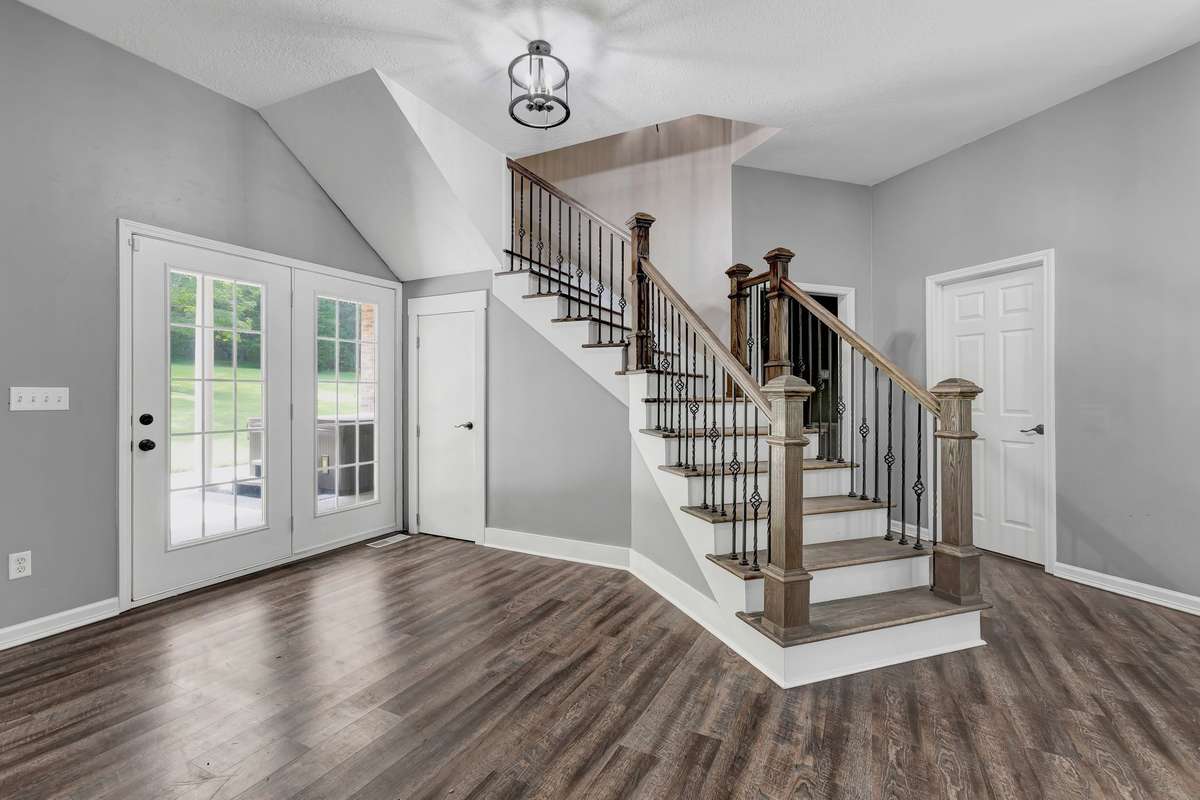 Stairs leading to BRAND NEW second level finished out in 2024