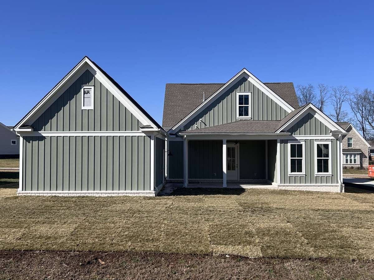 The back covered porch looks out to a beautiful large backyard