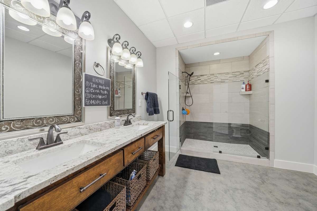 Basement level bathroom. Double vanities and Tiled, walk in shower.