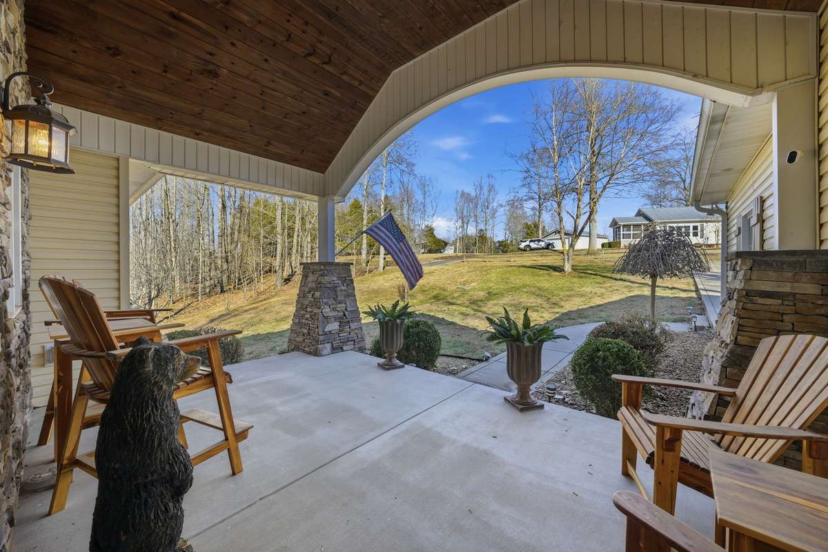 This gorgeous covered front porch has so much charm and gorgeous views!