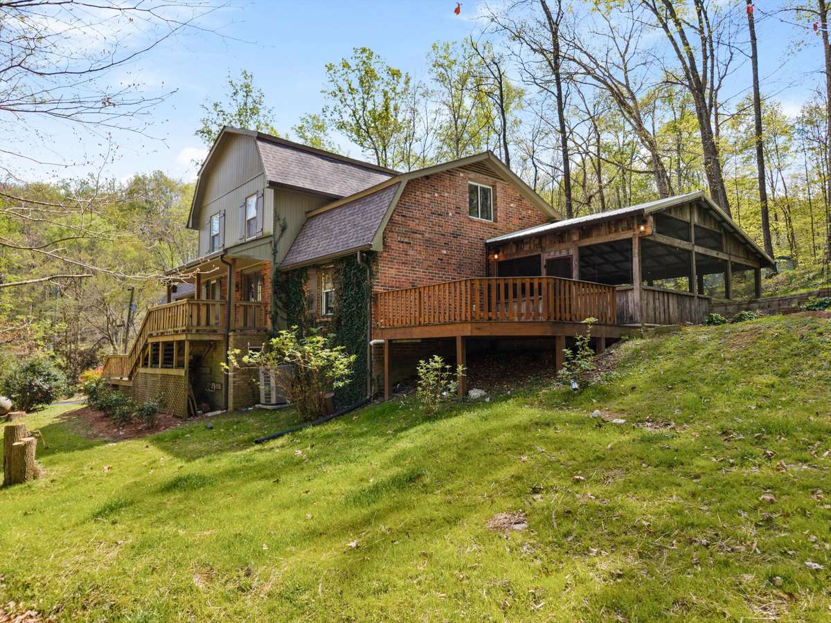A unique setting with a flat yard for entertaining and picturesque slopes filled with trees and rolling views.