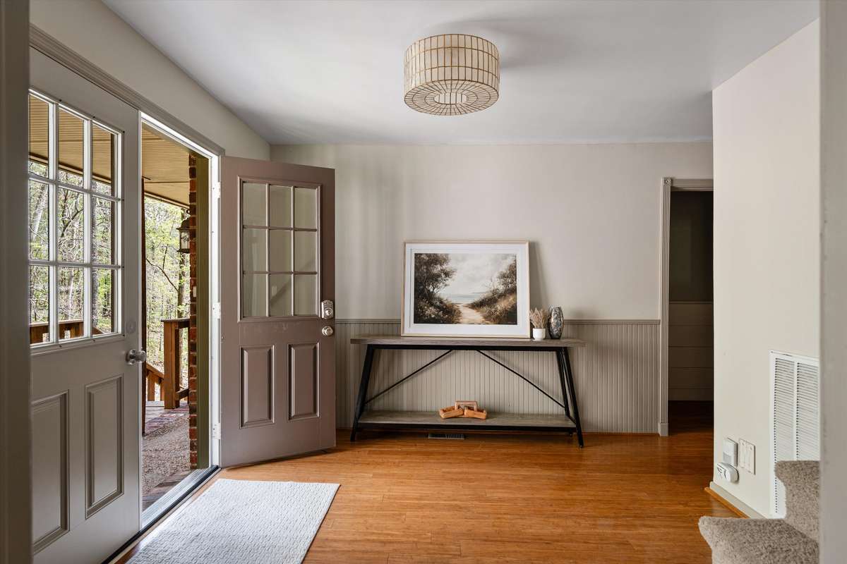 A large front entry with a beautiful updated light fixture.