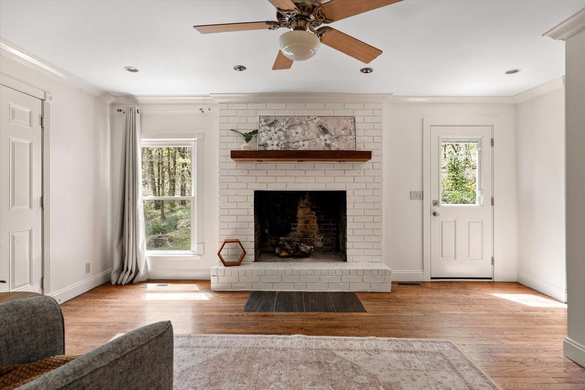 A cozy den anchored by a charming wood-burning fireplace—perfect for relaxing evenings at home.