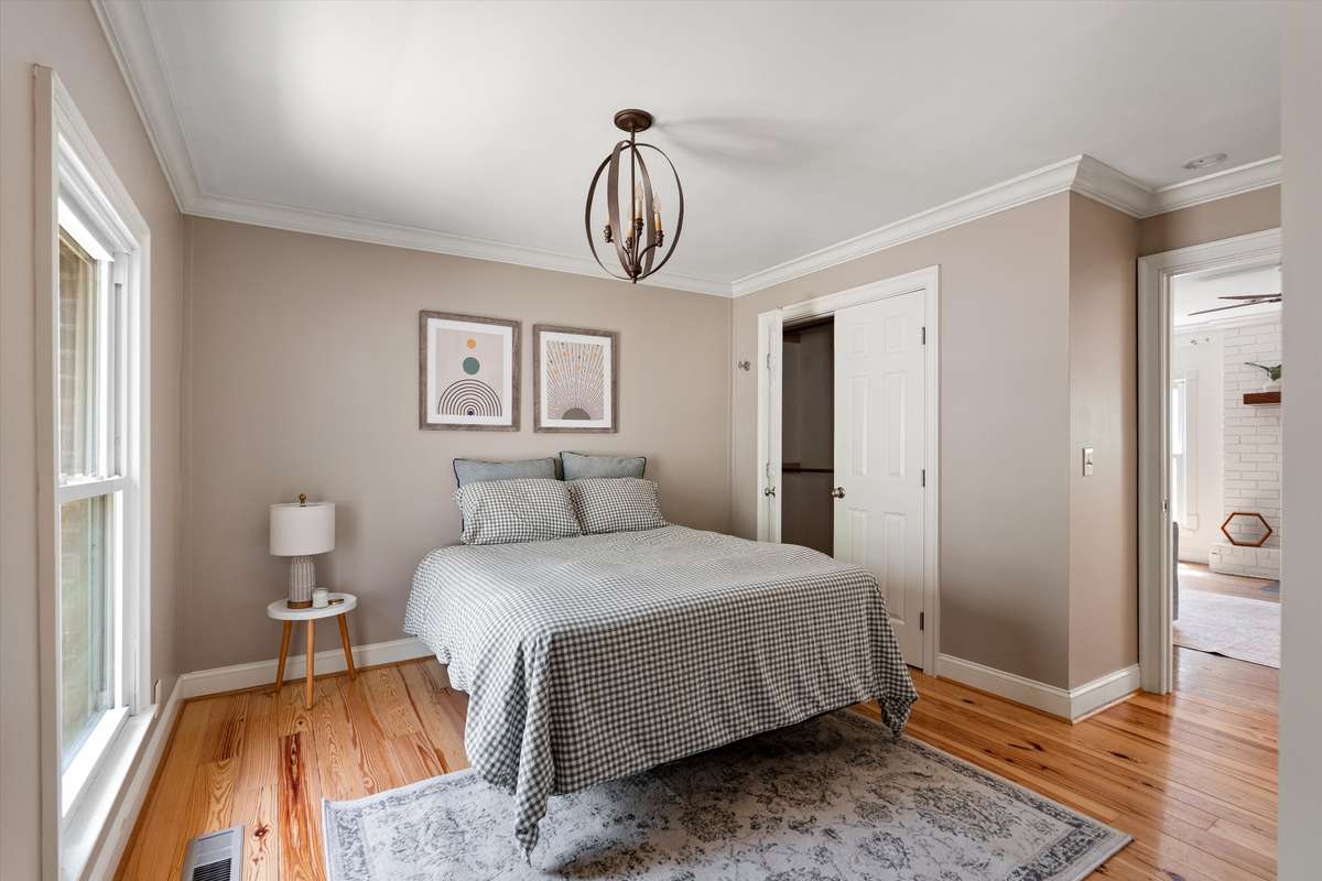 The main-floor primary suite offers a peaceful retreat with a large closet, sitting area for reading, and private bath.