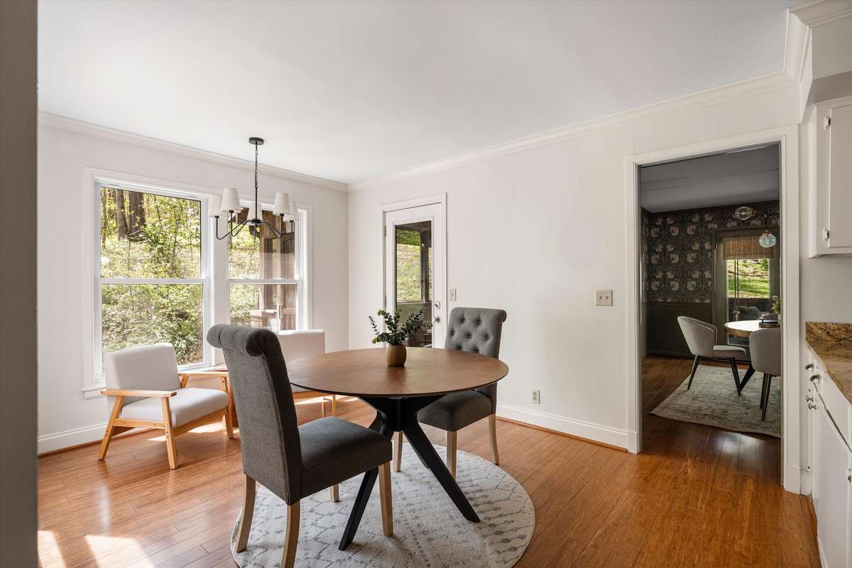 A bright and versatile breakfast area—ideal for casual dining or a cozy sitting space—highlighted by incredible windows and peaceful views.