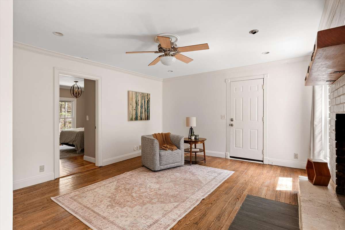 Cozy up in this inviting den where a wood-burning fireplace sets the tone for relaxed living.