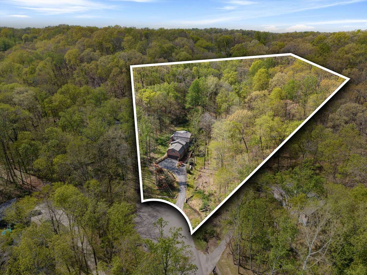 A rare 2-acre wooded retreat tucked away on a quiet cul-de-sac.
