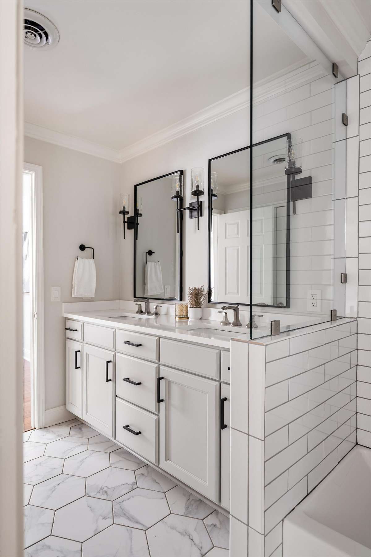 Designed with both style and function in mind, this updated bath includes double vanities and a gorgeous walk-in shower.