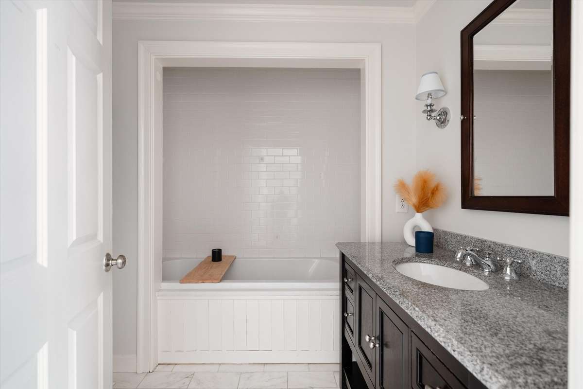 The primary bath combines style and comfort with an updated vanity and a deep tub/shower combo perfect for a great soak.