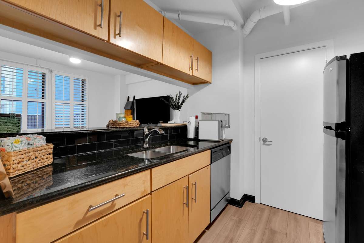 Galley style kitchen with ss appliances and a panty