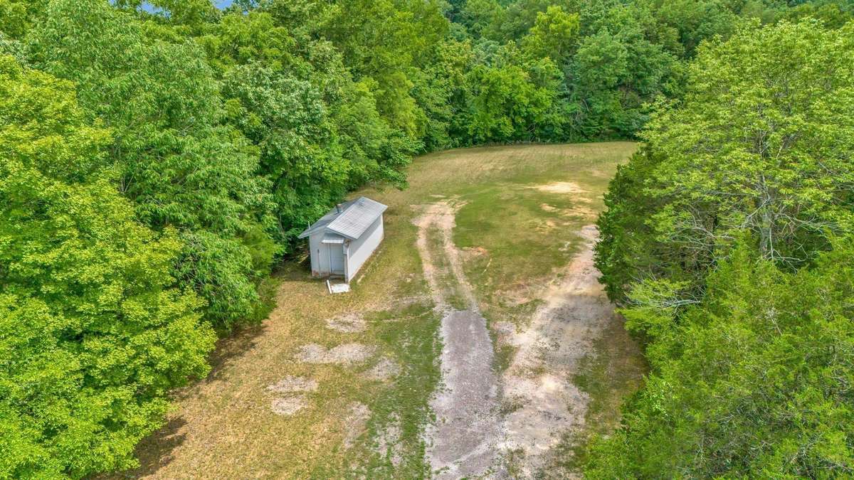 POTENTIAL "DREAM HOME SITE"???
LARGE OPEN Field Area that was used as Parking....
Currently has a Public Block Restroom Building
There is an Approved Septic System per the Seller but the Records cannot be located