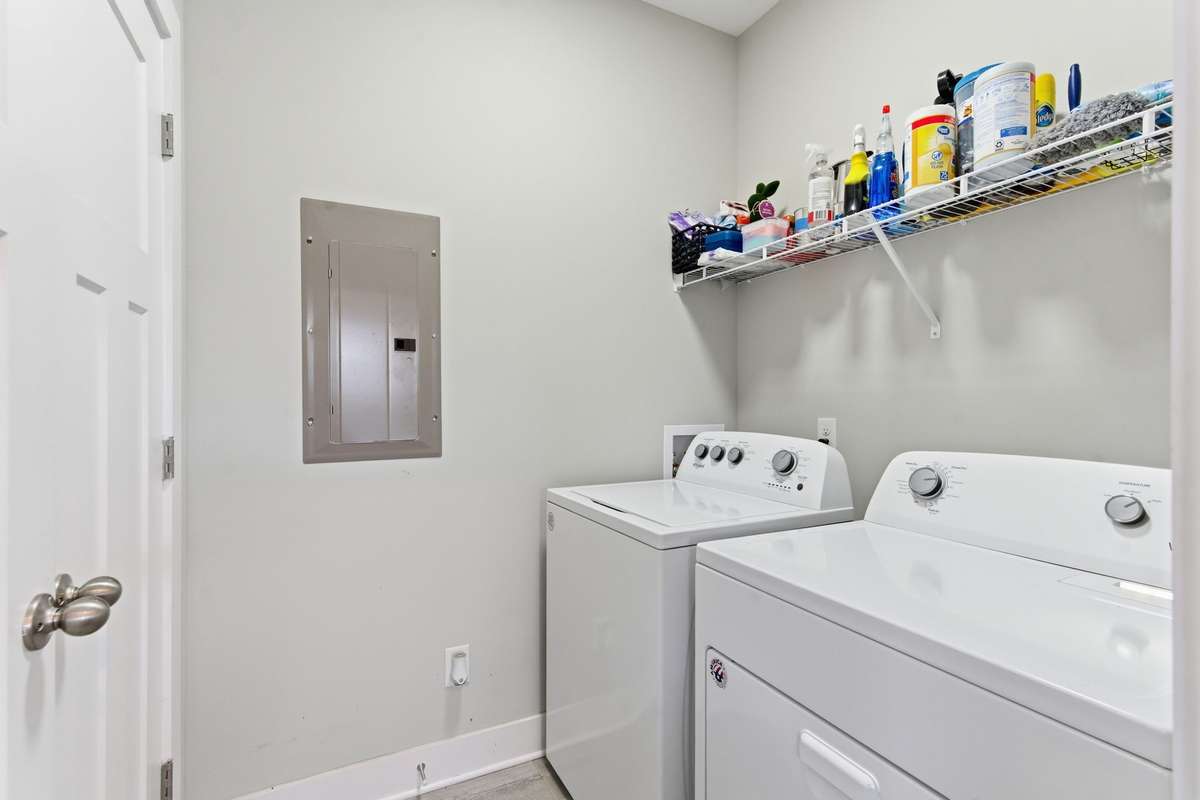 Convenient laundry room with additional storage space.