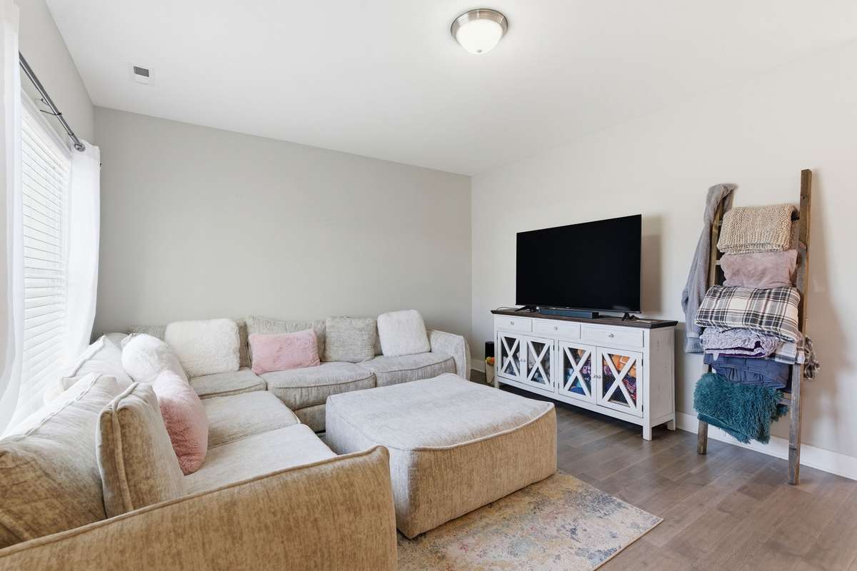 Enter into the bright and open living room that offers a comfortable gathering space.
