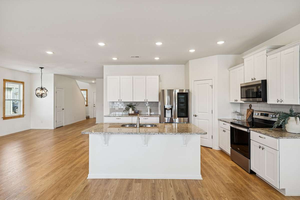 Large Island, Granite Countertops, and Tiled Backsplash