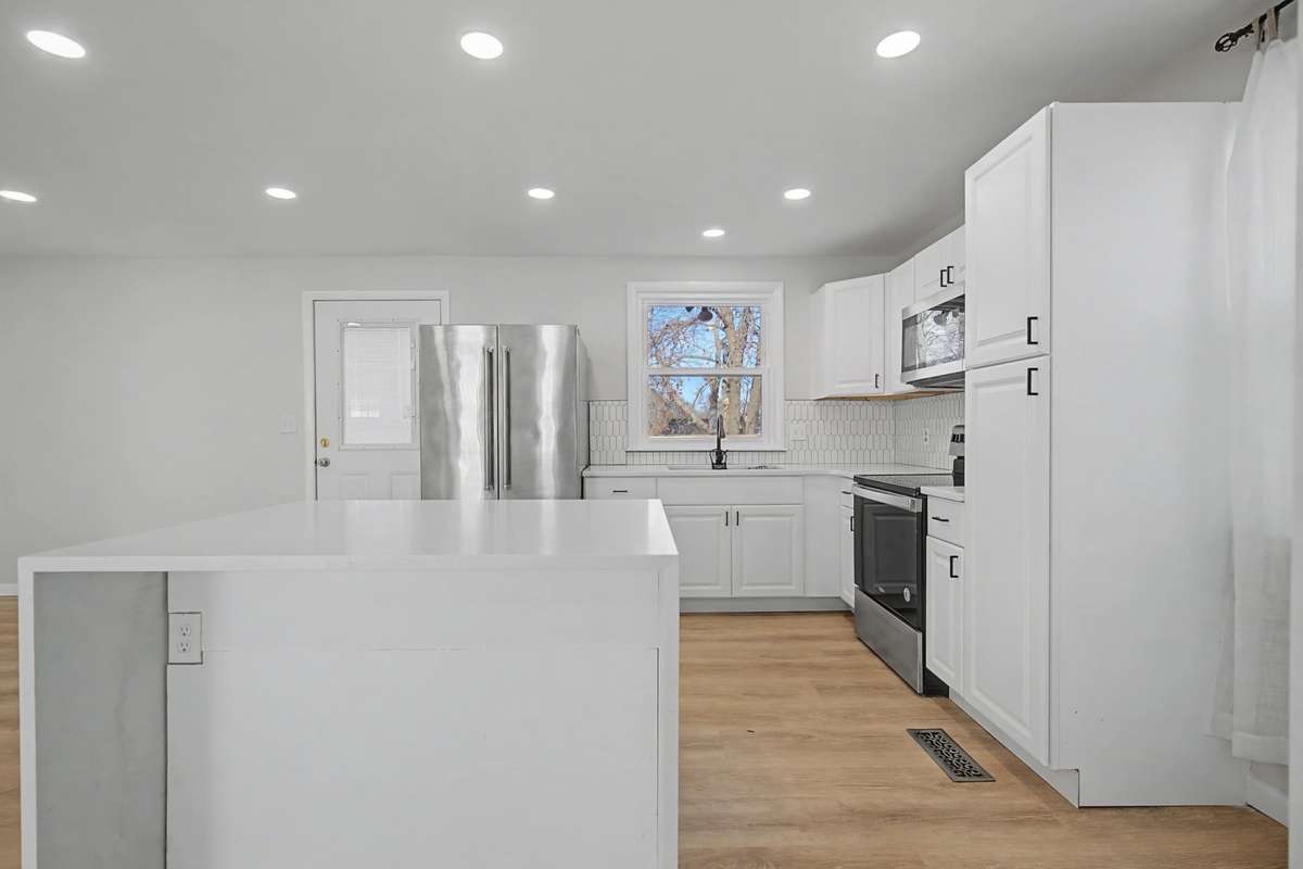 Large Kitchen Island with waterfall quartz countertops
