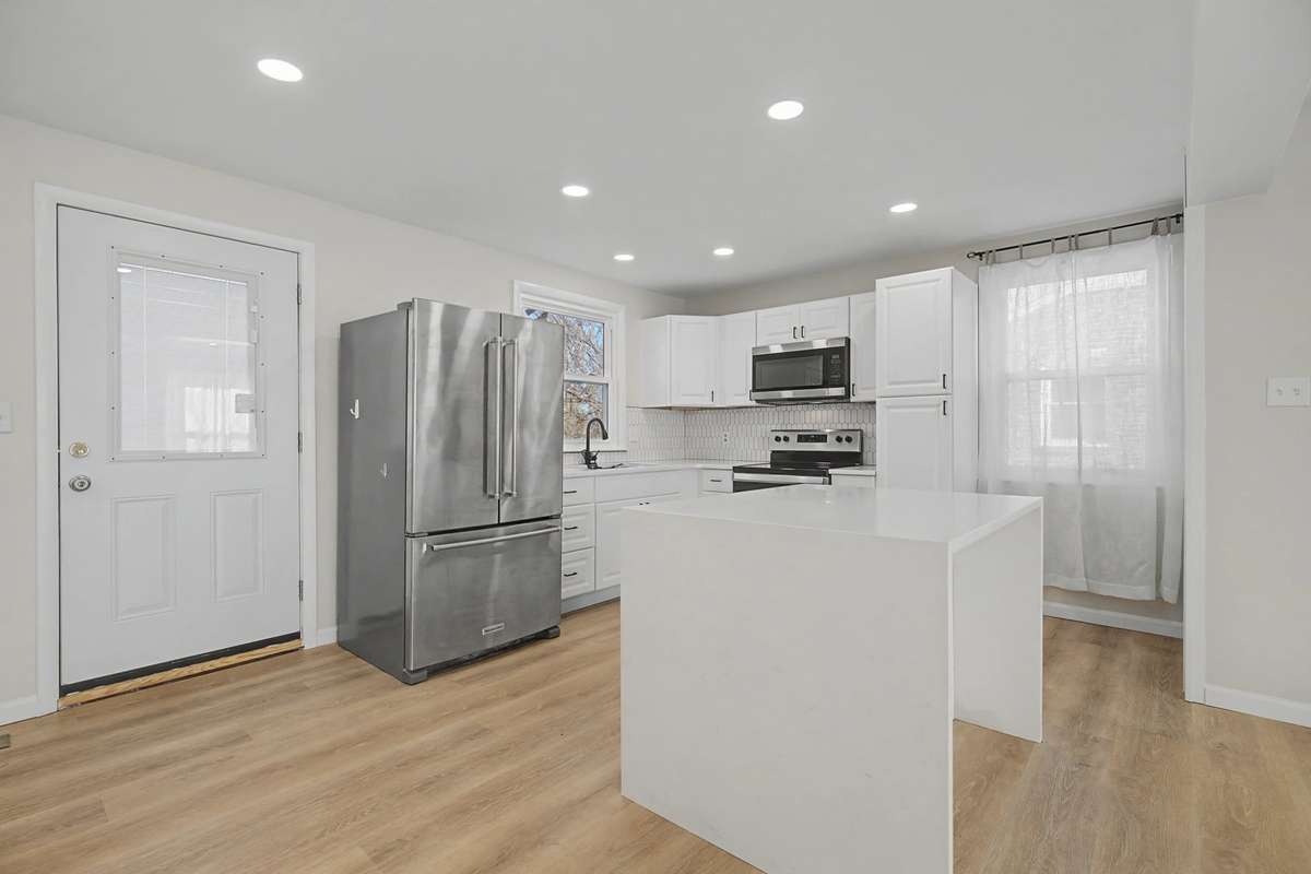 Large Kitchen Island with waterfall quartz countertops