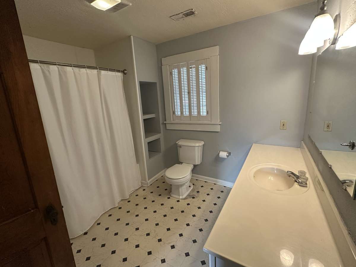 Full bathroom with tub/shower combo. Window faces back yard