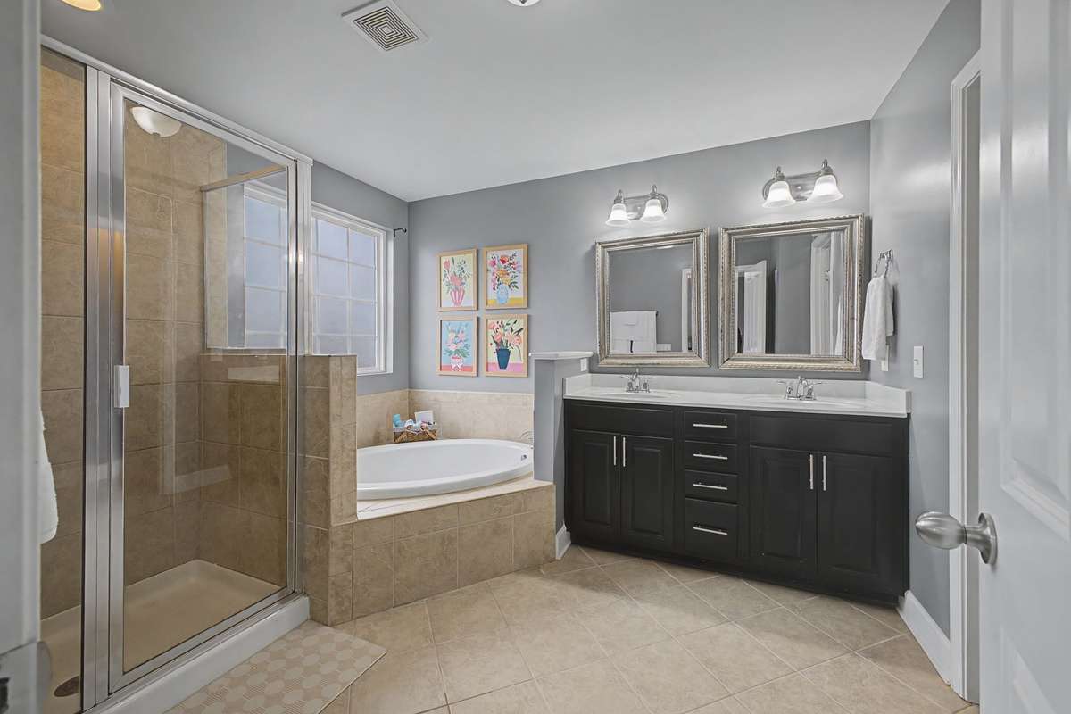 Spacious bathroom with double vanity, soaking tub and separate shower