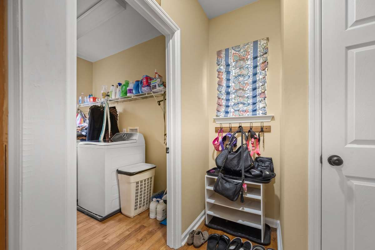Separate laundry room tucked away off the kitchen/garage entry