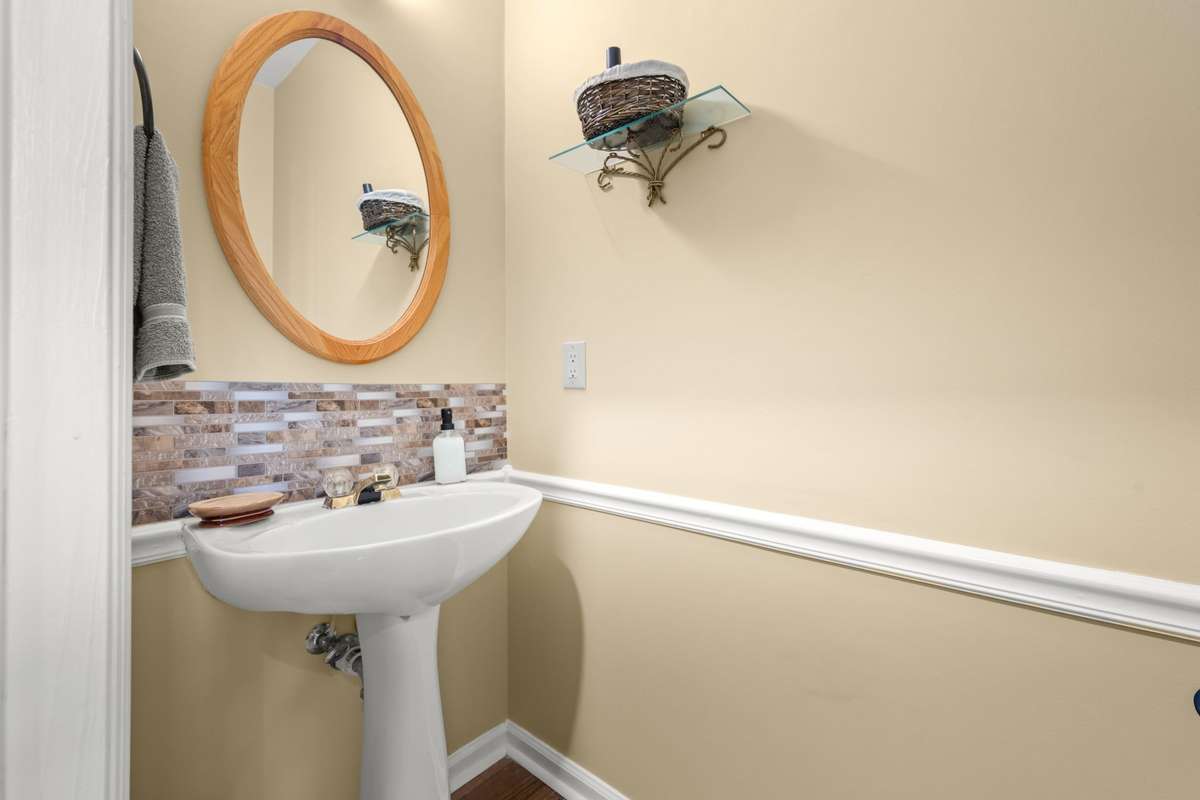 Downstairs half bath located in the hallway just off foyer
