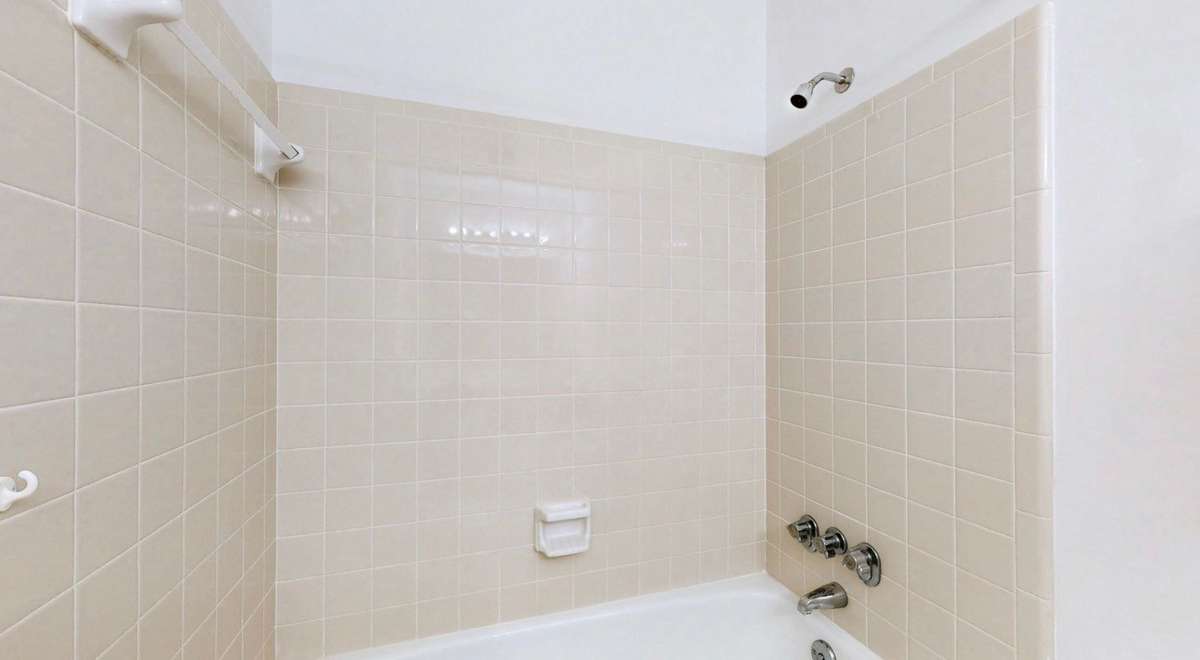 Tub with Tile shower surround.