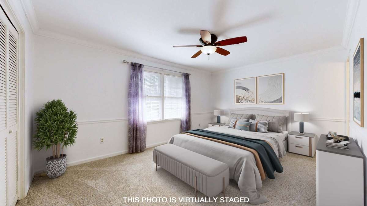 Primary bedroom suite with New carpet, ceiling fan and nice trim work.