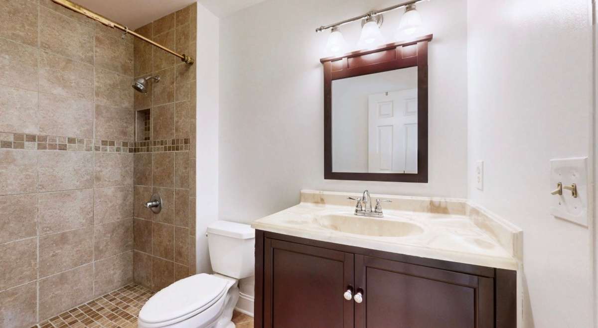 Updated vanity and large walk-in tile shower.