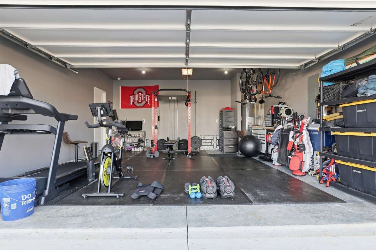 Two car garage currently is being used as an exercise room.