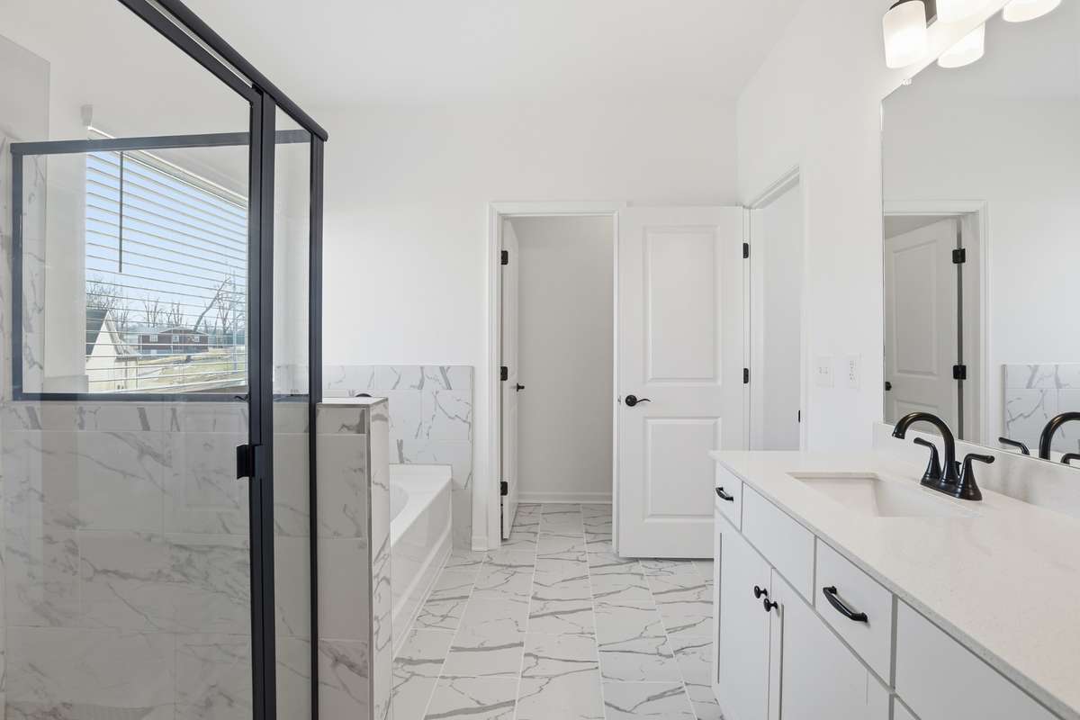 Primary bath with oversized shower and garden tub.