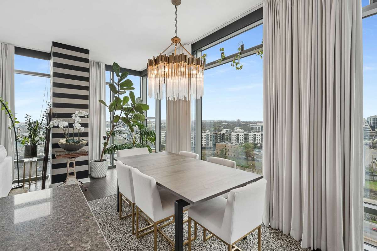 Dining area with custom lighting and sweeping views of the city and rolling hills