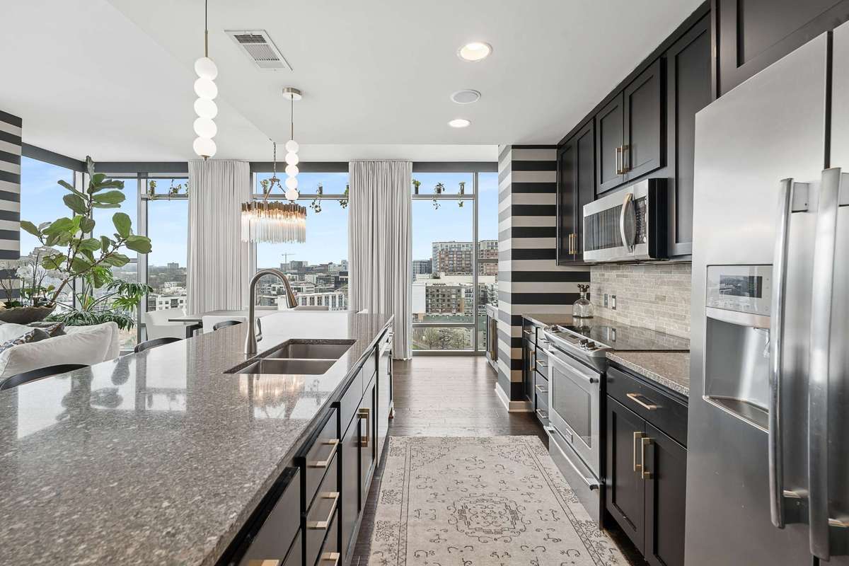 Open and sun drenched SS Kitchen with ample bar seating.
