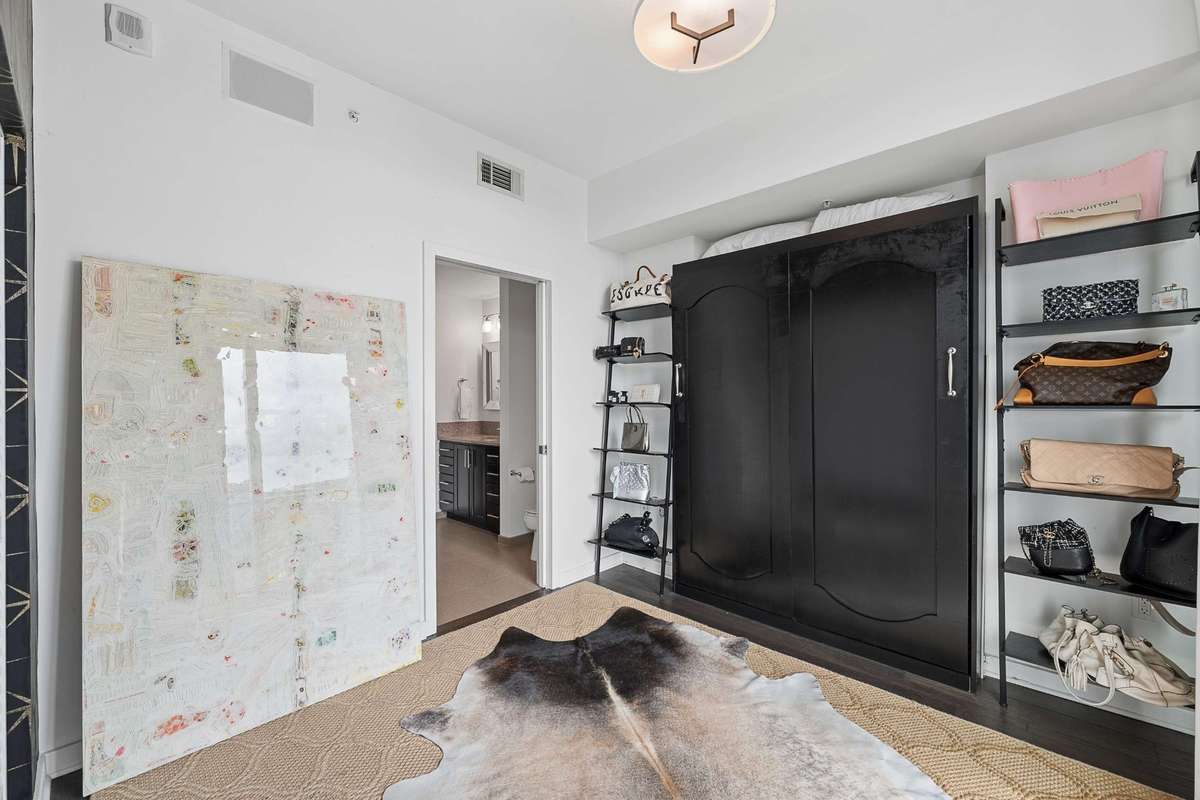 Secondary bedroom has a Murphy Bed wall unit (that will convey) allowing for multiple uses of this bedroom/hobby room.