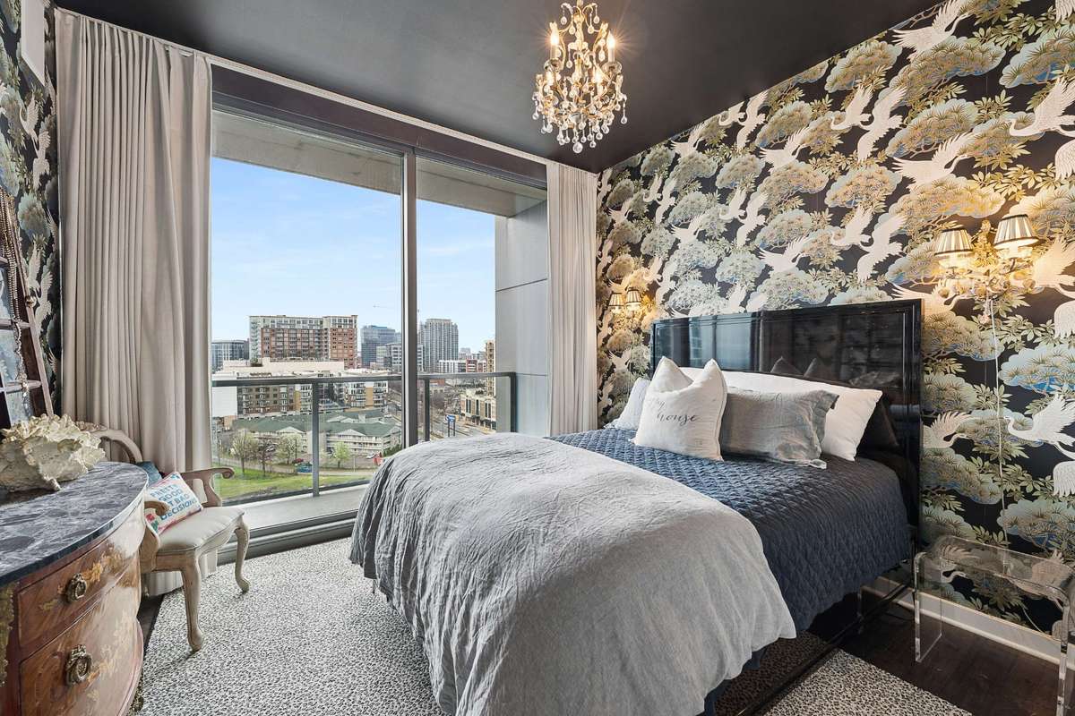 Primary bedroom with your own private balcony to greet the city each day (sconces and chandelier will not convey- replacement chandelier will be installed by seller)