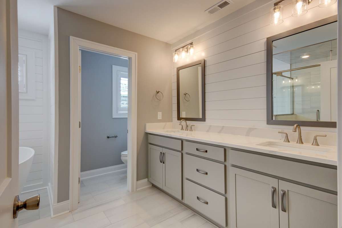 double vanities, private water closet, full tile shower and separate soaking tub complete this master bath