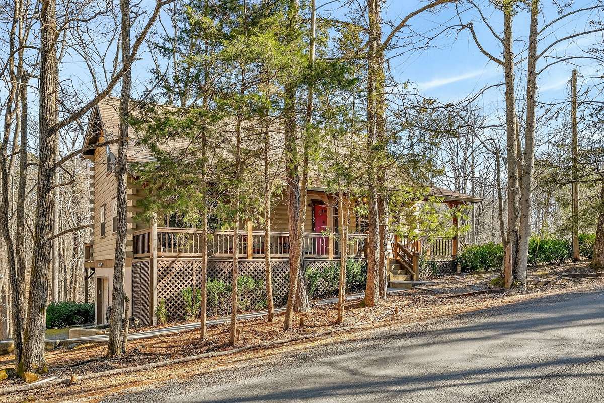 Mature pine and hard wood trees provide a natural barrier to the home on 1105 Fairways Drive.
