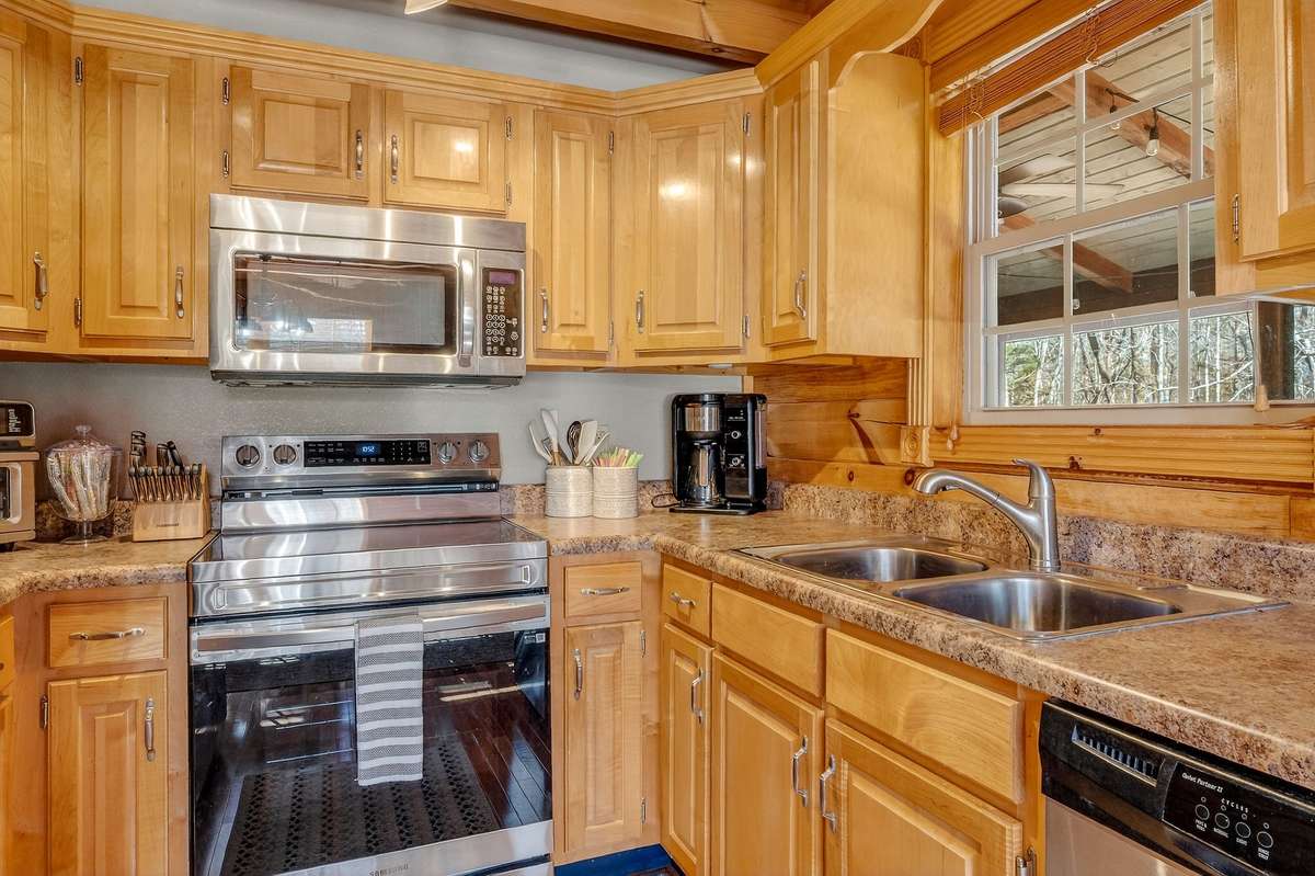 Window above sink has a great view of the screened in deck, open deck and back yard.