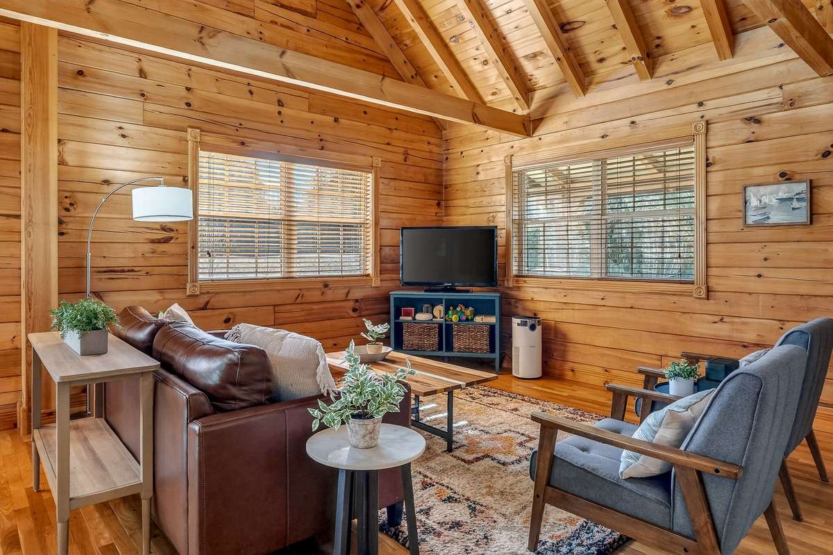 Volume ceilings featuring exposed rafters and collar ties throughout the first and second floor.