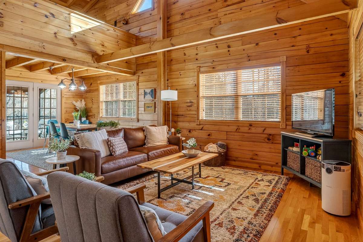 Abundant natural sunlight warms the pine paneling in this cozy retreat.