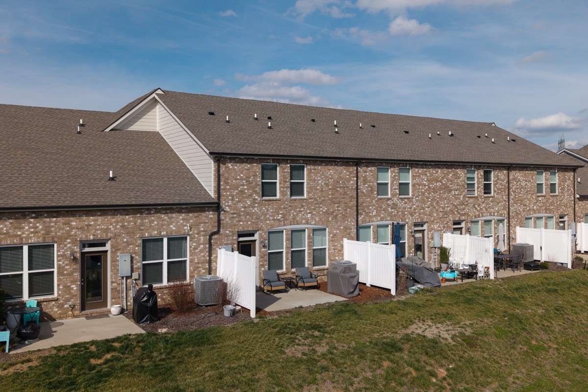 Classic brick exterior with a private patio, vinyl privacy fencing, and a spacious backyard area— a great outdoor space to relax and unwind.