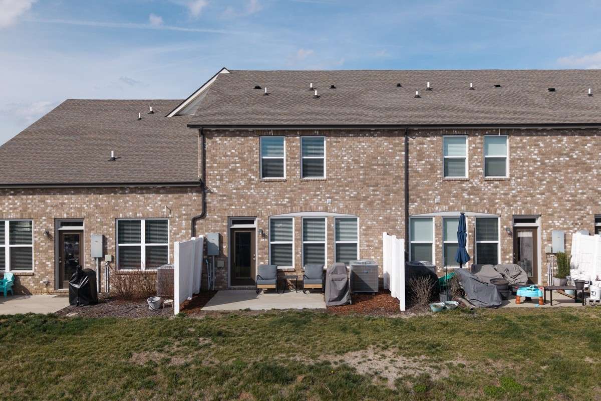 Classic brick exterior with a private patio, vinyl privacy fencing, and a spacious backyard area— a great outdoor space to relax and unwind.