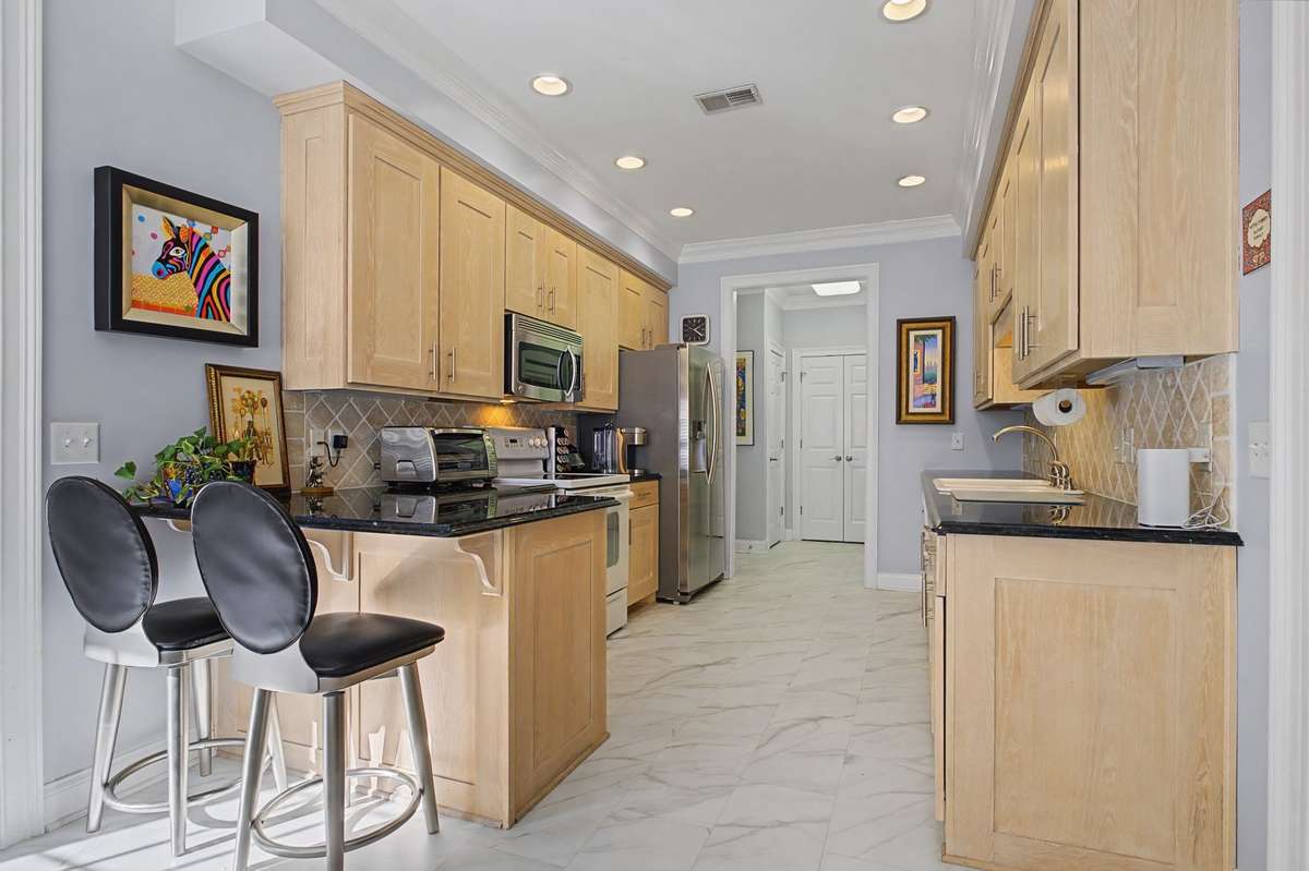 Kitchen has breakfast bar and granite counter tops.