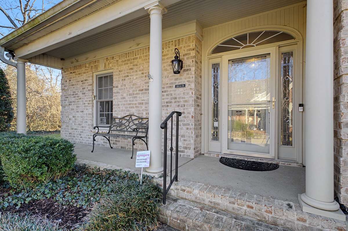 Lovely porch in the front of this brick home.