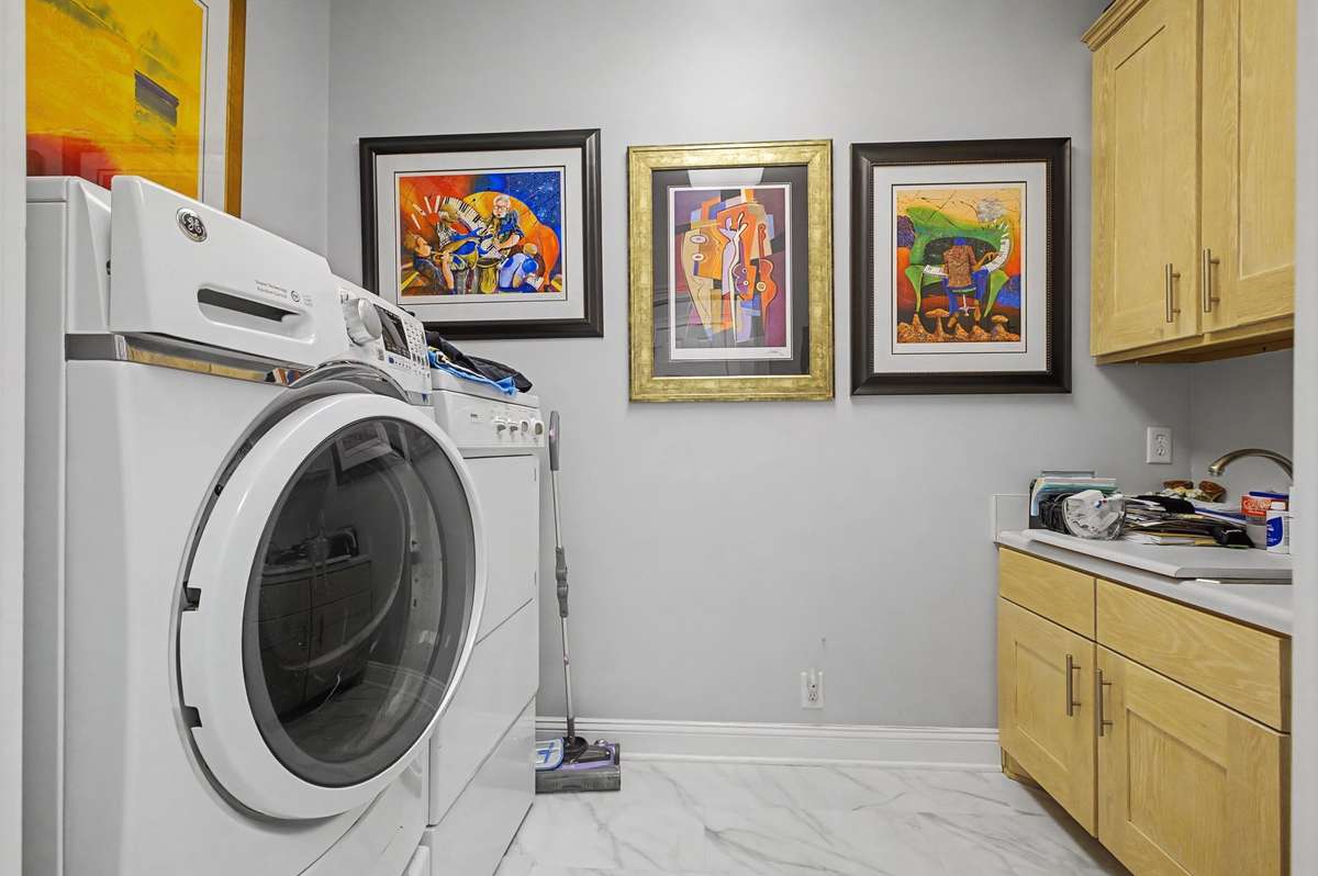 Laundry room is off of kitchen and has built in cabinets and sink. Appliances convey with home.