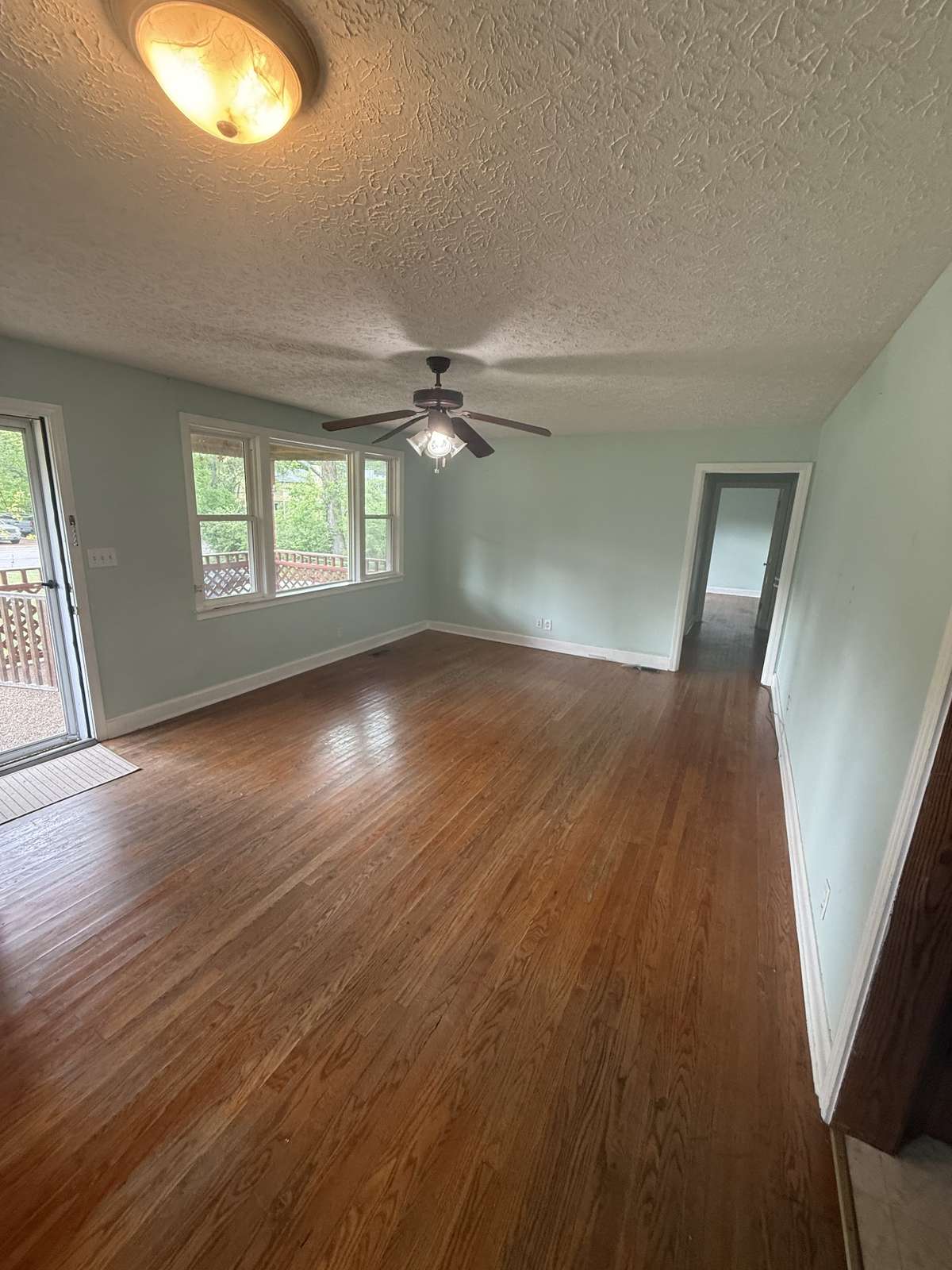Open, airy front room with picture window and original hardwood floors
