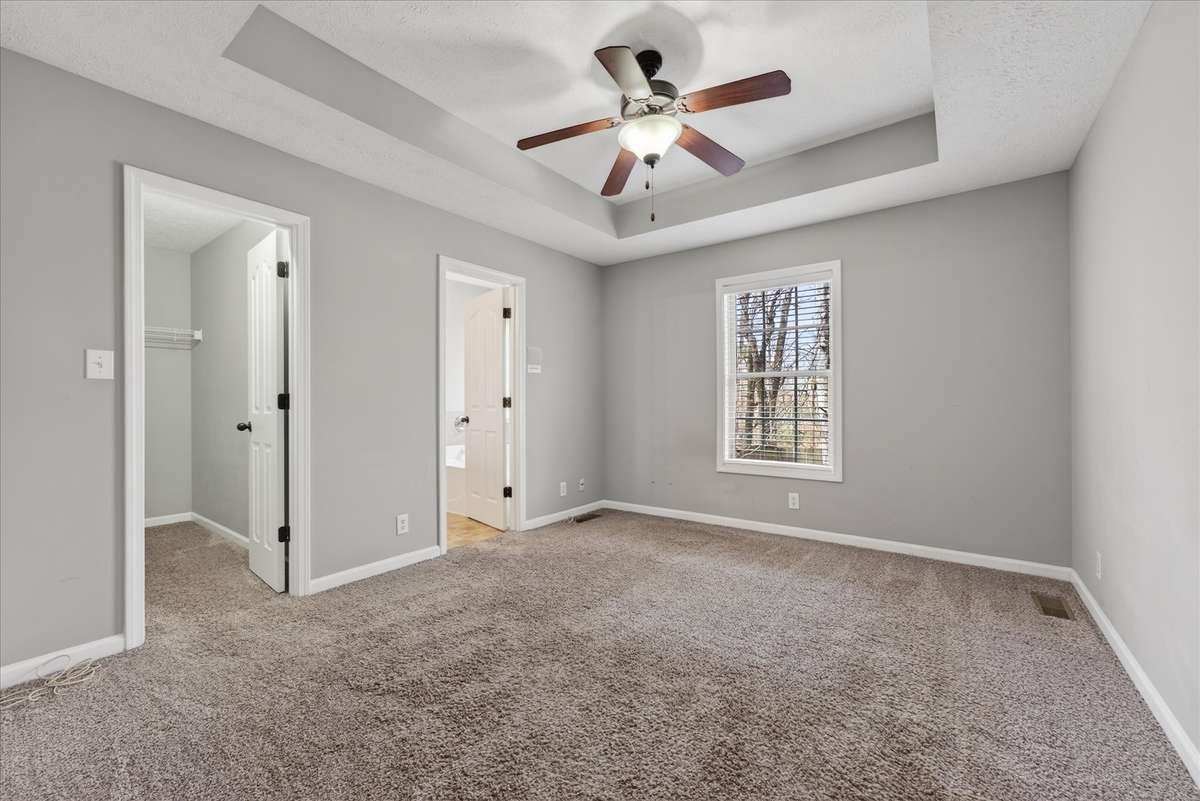 Primary bedroom has trey ceilings as well.